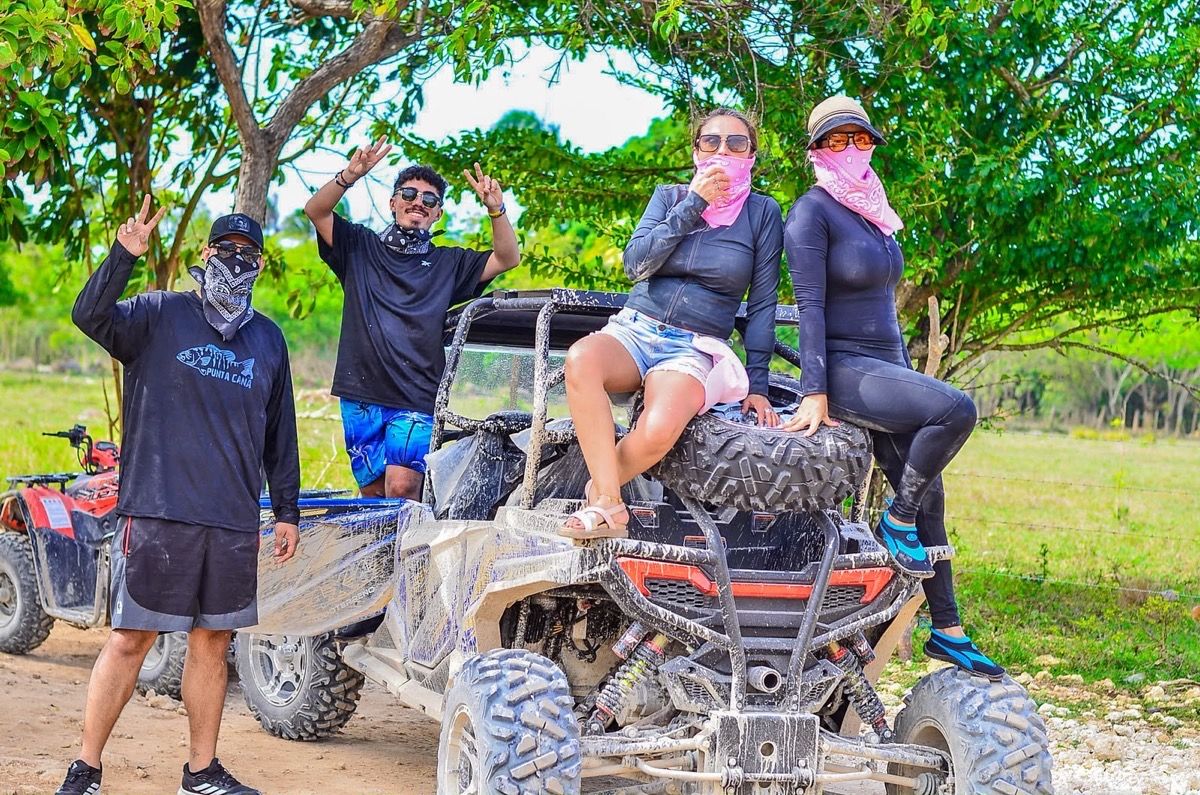A group of travellers posing by their buggy at the end of the route