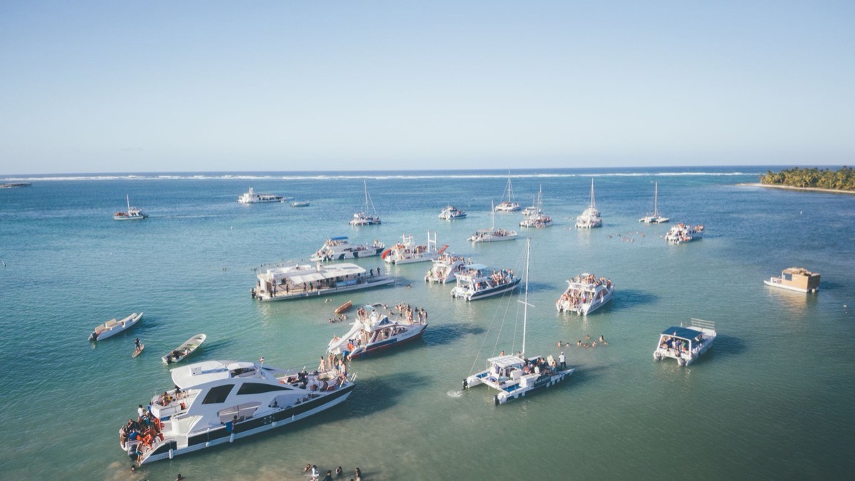 Catamarans anchored in turquoise water, seen from above