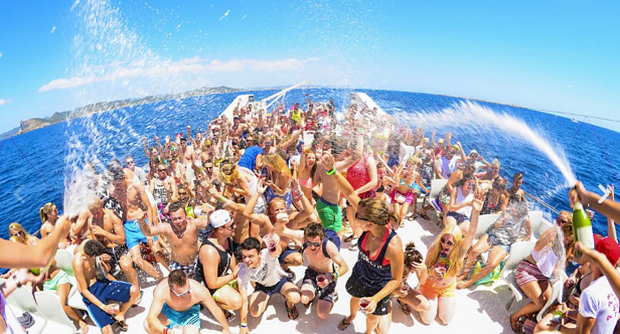 The deck full of people celebrating, with the sea behind