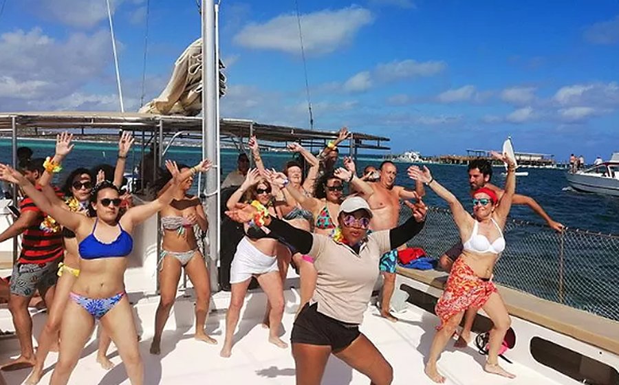 A group dancing on deck with the entertainer