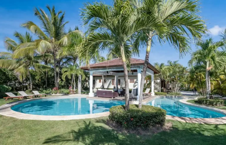 The second villa, with its own pool and gazebo among palms