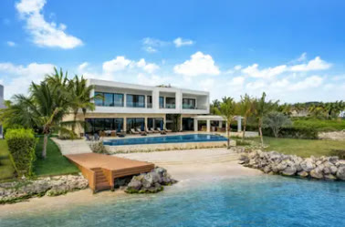 The villa seen from the water, with its pool