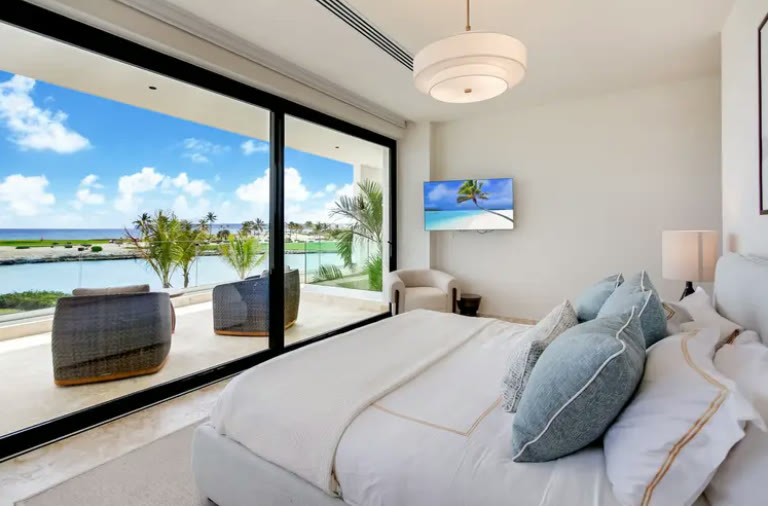 A bedroom opening onto the terrace with a lagoon view