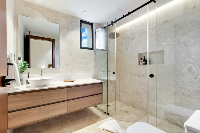 A bathroom with a walk-in shower and double basin
