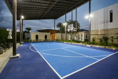 A floodlit basketball court on the property