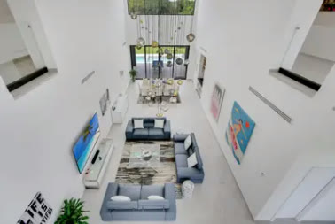 The double-height living room seen from the upper gallery