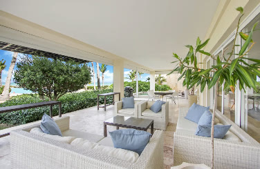 A living room opening onto the terrace with an ocean view