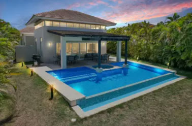 The villa at night with the pool lit