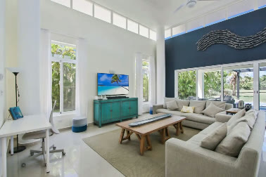 A living room with a TV and a blue wall