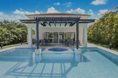 The pool with the pergola and outdoor dining area
