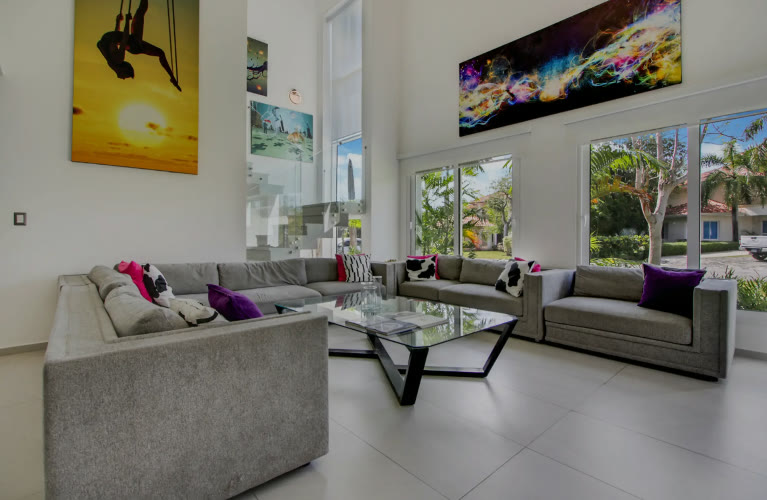 A double-height living room with grey sofas