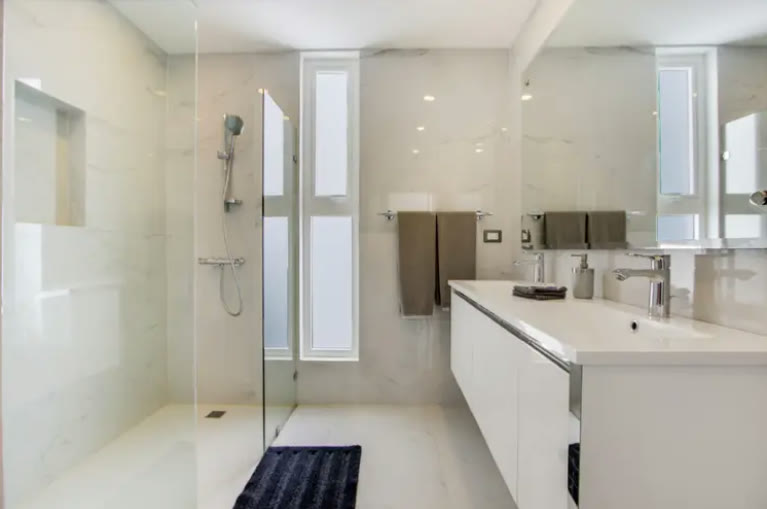 A white bathroom with a walk-in shower