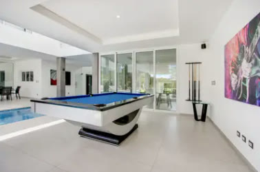 A games room with a pool table