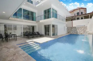 The villa pool with its three-storey white façade