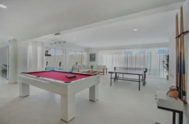 A games room with a pool table and table football
