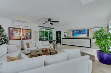 A double-height living room with white sofas