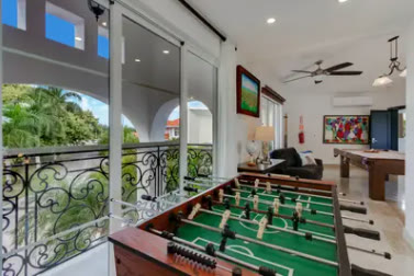 A games room with table football and a pool table