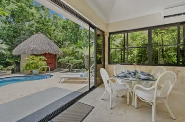 A glazed terrace opening onto the pool