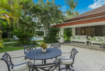 An outdoor dining area beside the pool